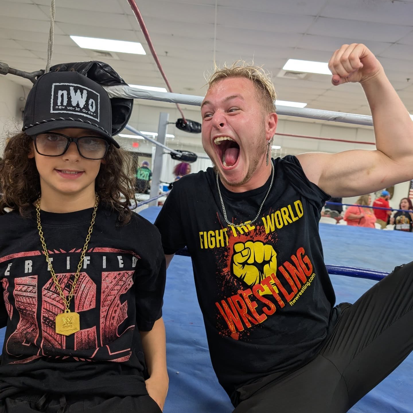 Trystan poses ringside with a professional wrestler
